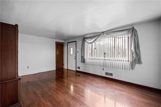 unfurnished room featuring dark wood-type flooring