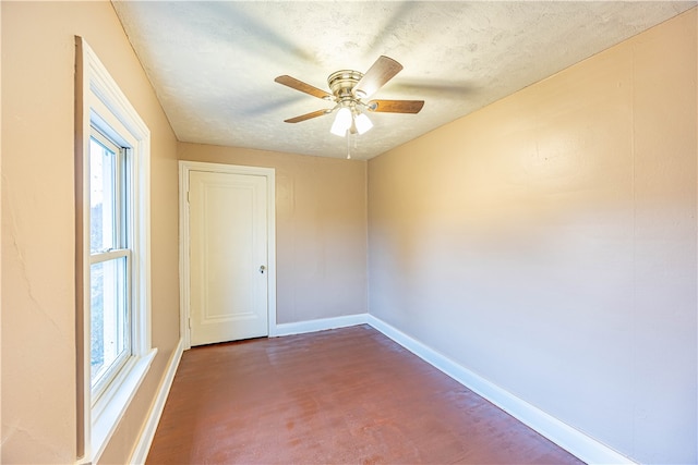 spare room with ceiling fan and a textured ceiling