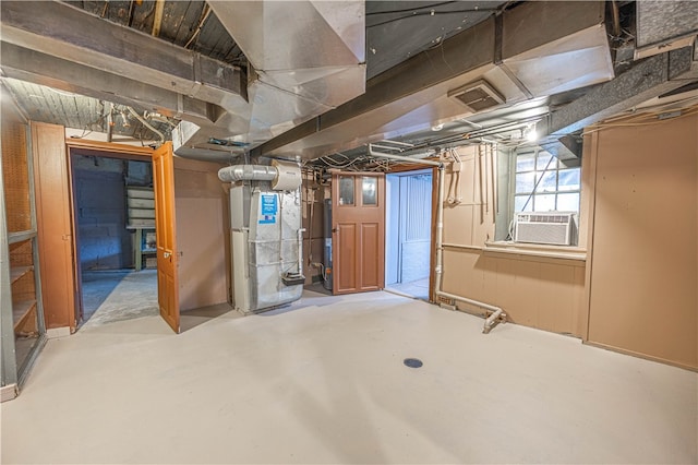 basement with cooling unit, gas water heater, and heating unit