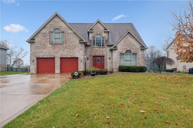 view of front of home featuring a garage and a front yard