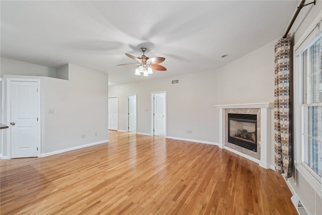 unfurnished living room with ceiling fan, light hardwood / wood-style floors, and lofted ceiling