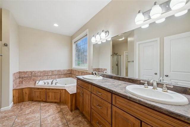 bathroom featuring plus walk in shower, vanity, and tile patterned flooring