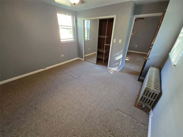 unfurnished bedroom featuring carpet flooring and a closet