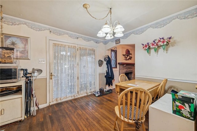 357 E Mcmurray Rd, Peters Twp, PA 15317 - dining space featuring a chandelier, ornamental molding, dark wood-style flooring, and a fireplace