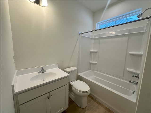 full bathroom featuring hardwood / wood-style flooring, vanity, toilet, and tub / shower combination