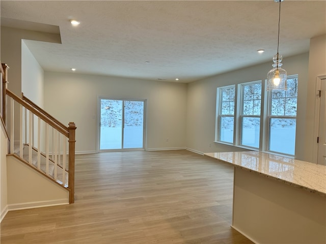 unfurnished living room with light hardwood / wood-style flooring