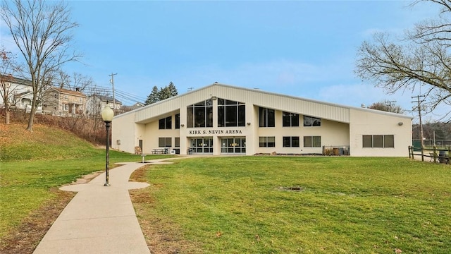 back of property featuring a lawn