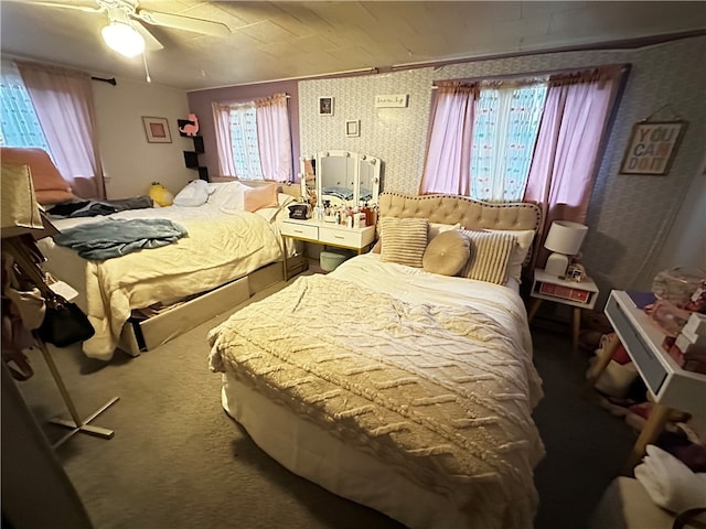 carpeted bedroom with ceiling fan and ornamental molding