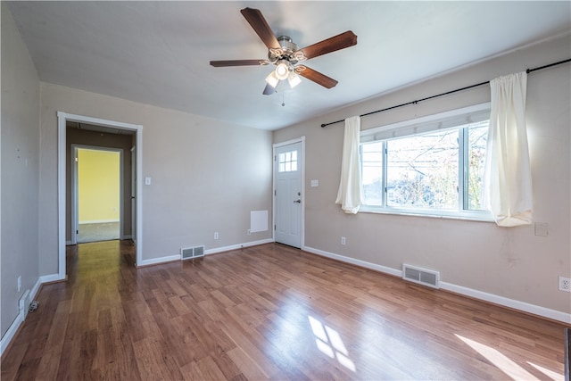 spare room with ceiling fan and wood-type flooring