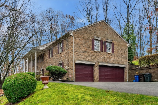 view of front facade with a garage and a front lawn