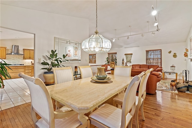 dining area with a chandelier and light hardwood / wood-style flooring