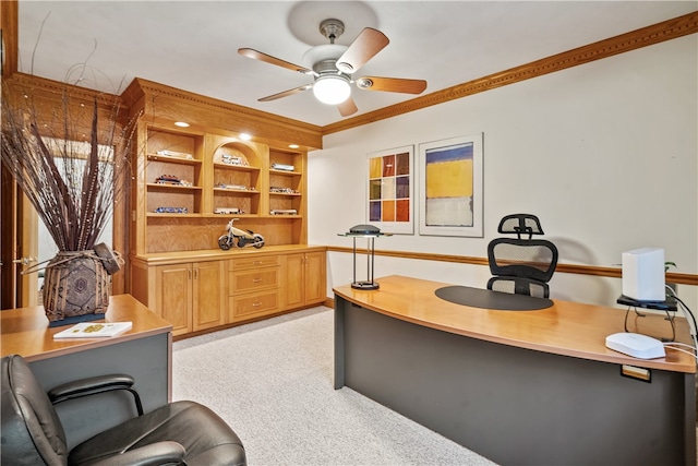 home office featuring light colored carpet, ceiling fan, and crown molding