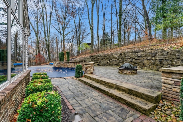 view of patio / terrace with an outdoor fire pit