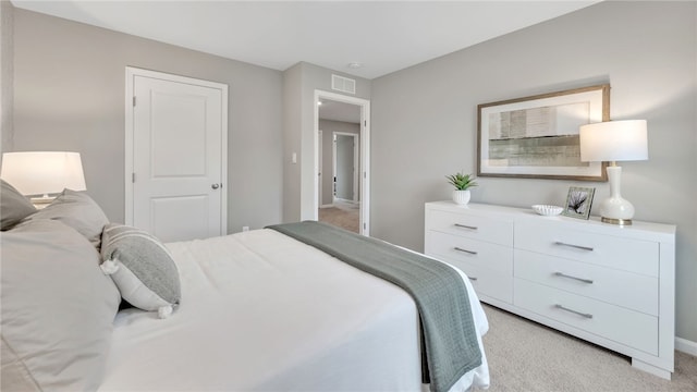 bedroom featuring light colored carpet