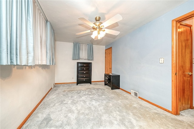 unfurnished bedroom featuring carpet flooring and ceiling fan