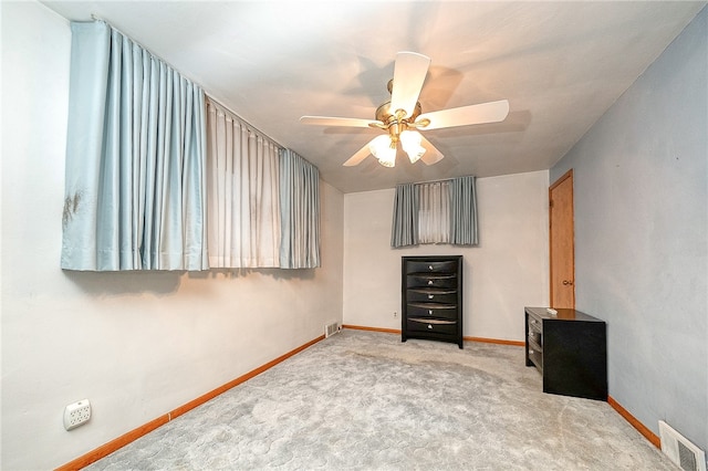 unfurnished bedroom featuring ceiling fan and light carpet