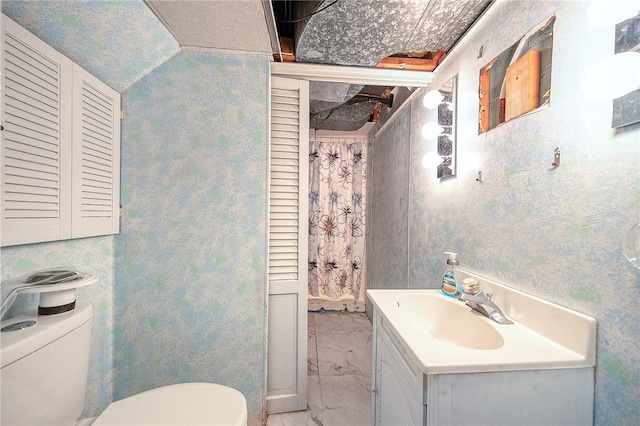 bathroom featuring vanity and toilet