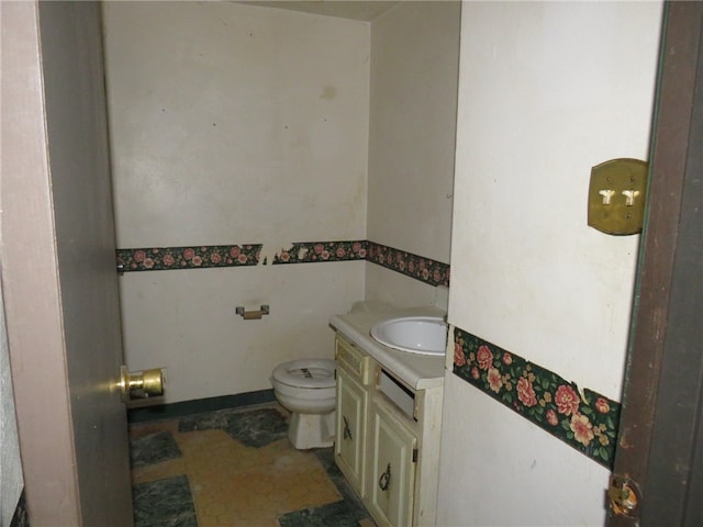 bathroom featuring vanity and toilet