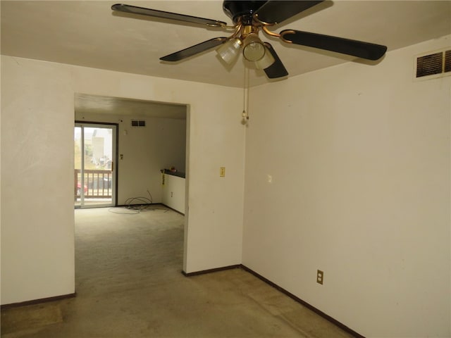 spare room with ceiling fan and light carpet