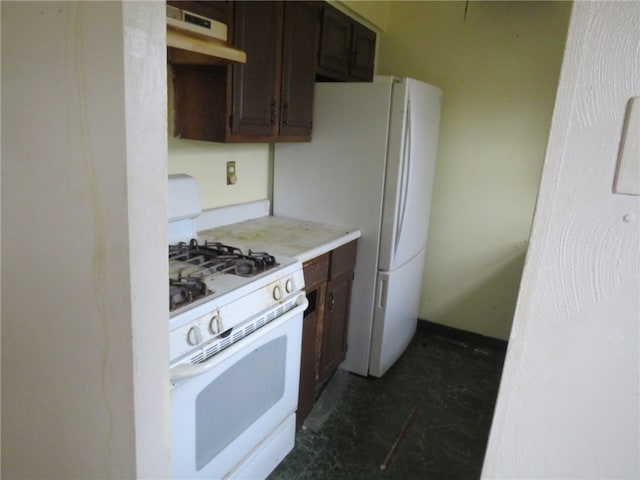 kitchen with white gas range and dark brown cabinetry