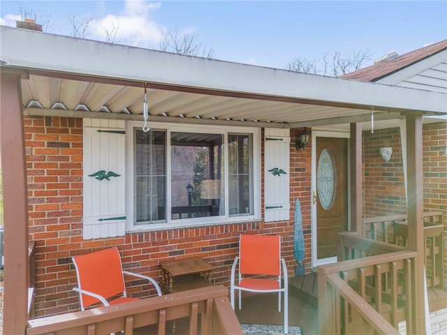 view of exterior entry with covered porch