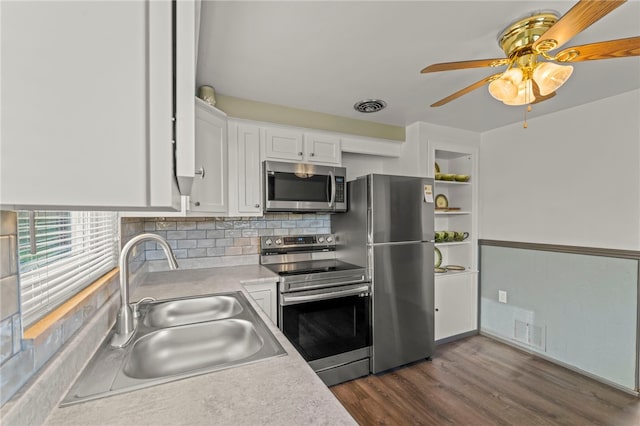 kitchen featuring white cabinetry, sink, dark wood-type flooring, tasteful backsplash, and appliances with stainless steel finishes