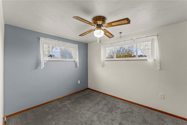 spare room featuring carpet flooring and ceiling fan