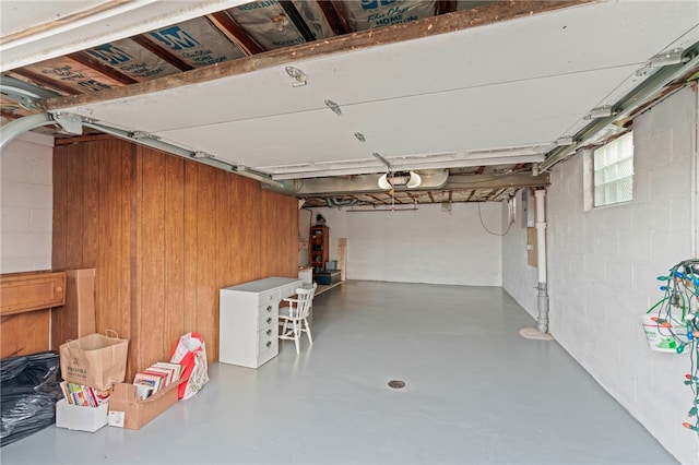 garage featuring wooden walls and a garage door opener