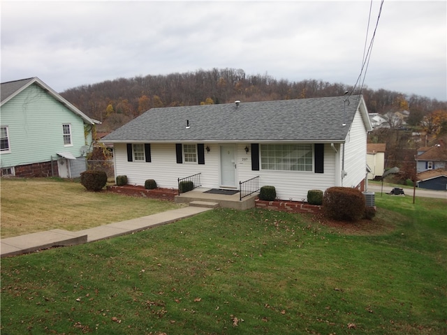 view of front of home featuring central air condition unit and a front yard