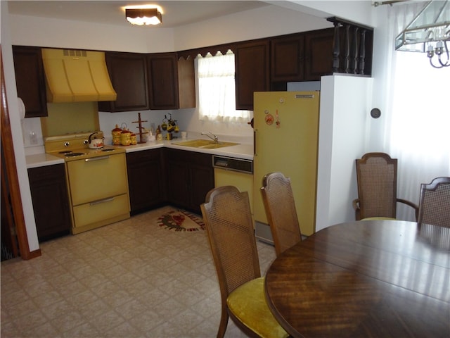 kitchen featuring white appliances, extractor fan, dark brown cabinetry, and sink