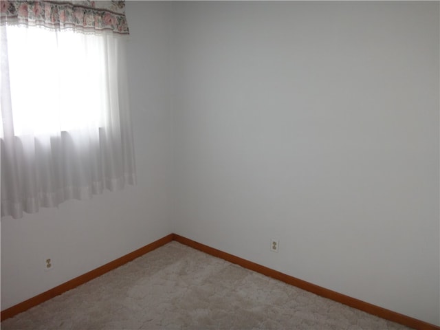 spare room with light colored carpet