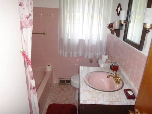 full bathroom featuring shower / bath combination with curtain, vanity, tile walls, tile patterned flooring, and toilet