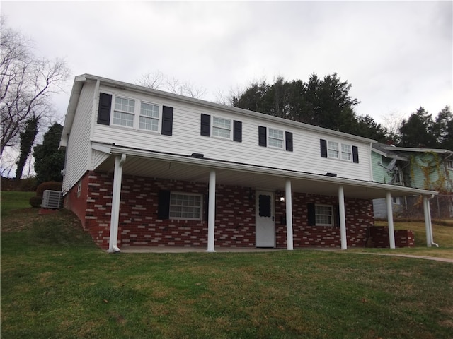 view of front facade with central AC, a front lawn, and a porch