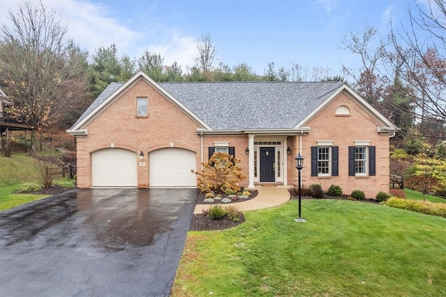 view of front of property featuring a front yard and a garage