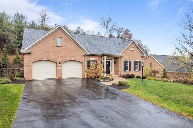 view of front of home with a front yard and a garage