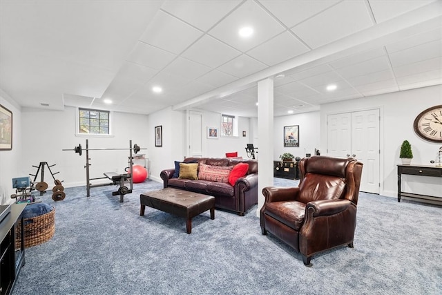 living room with a paneled ceiling and carpet floors