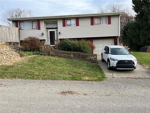 raised ranch with a front yard and a garage