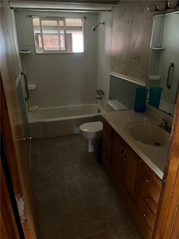 full bathroom featuring toilet, vanity, and washtub / shower combination