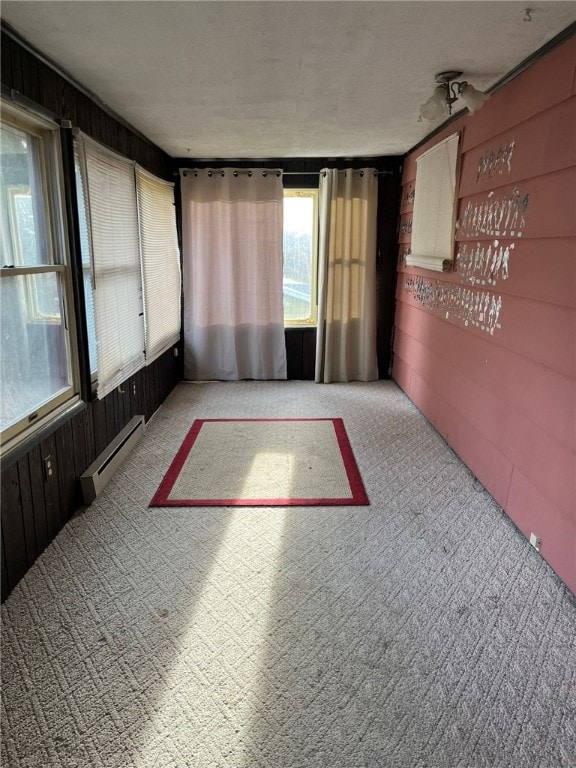 unfurnished sunroom with a baseboard radiator