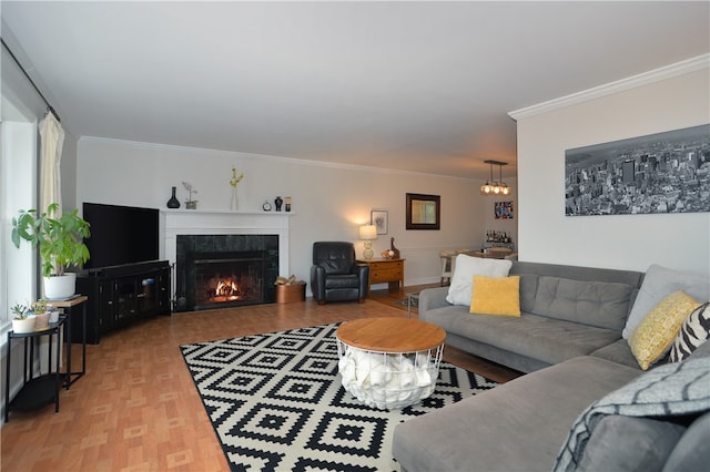 living room with hardwood / wood-style flooring, ornamental molding, and a tile fireplace