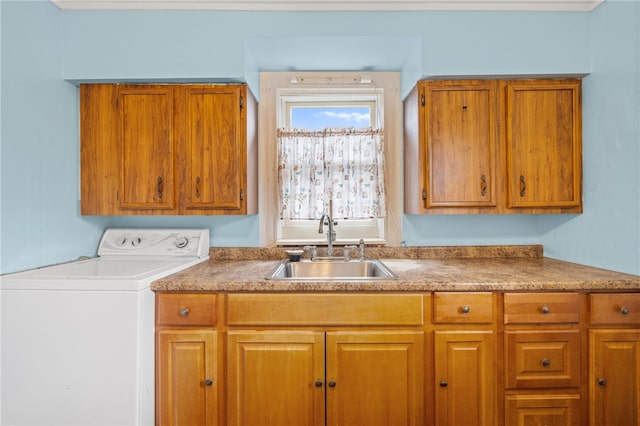 laundry area with cabinets, washer / dryer, and sink