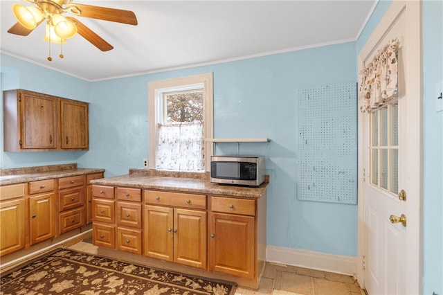 kitchen featuring ceiling fan and ornamental molding