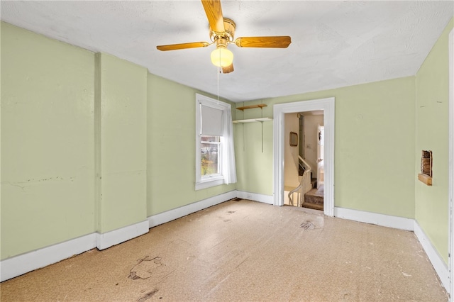 unfurnished bedroom with ceiling fan and connected bathroom