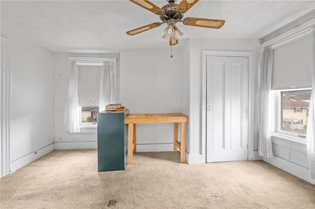 unfurnished bedroom featuring ceiling fan and light colored carpet