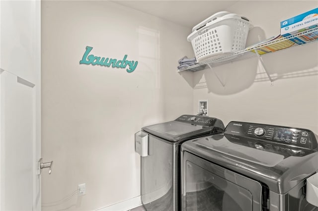 laundry room featuring washing machine and clothes dryer