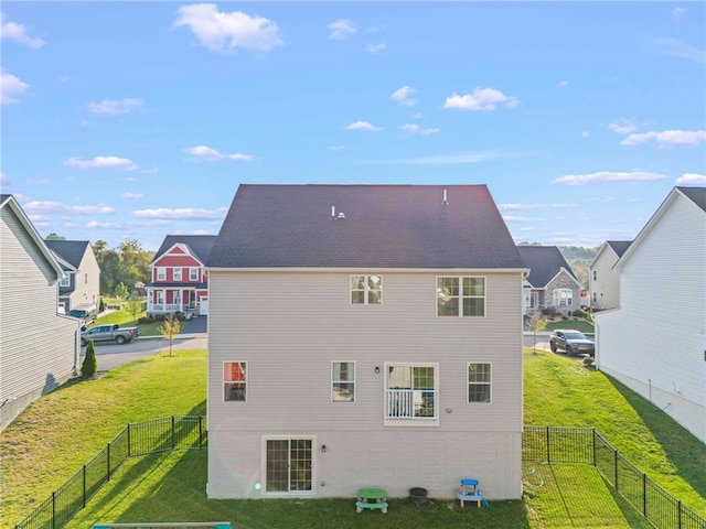 rear view of property with a yard