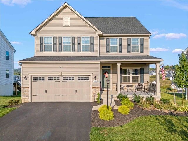 craftsman house featuring covered porch and a garage