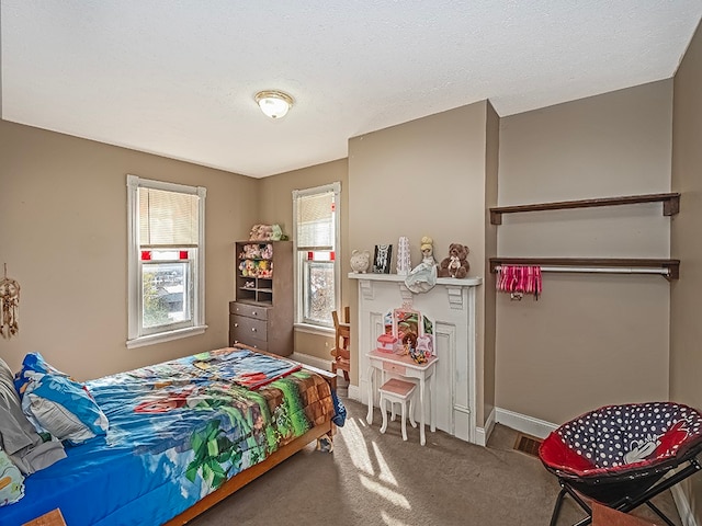 bedroom with carpet flooring and a textured ceiling