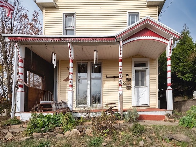 view of exterior entry with covered porch