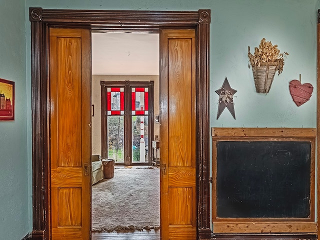 hallway with carpet floors